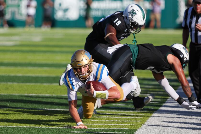 HONOLULU, HI - AUGUST 31: Ethan Garbers #4 of the UCLA Bruins dives forward.