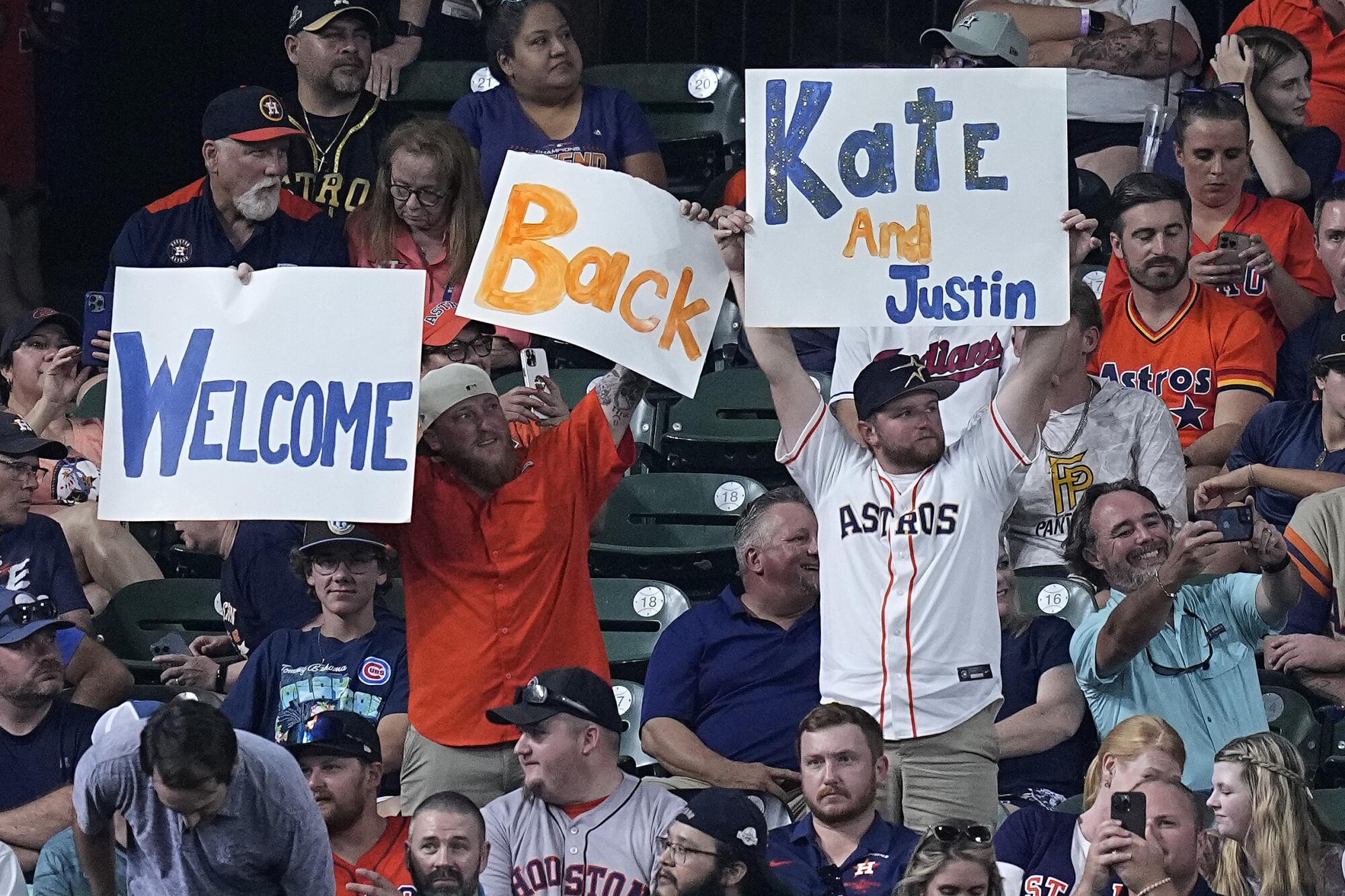 Fans hold up signs following the trade of Justin Verlander from the New York Mets to the Houston Astros on Aug. 1, 2023.