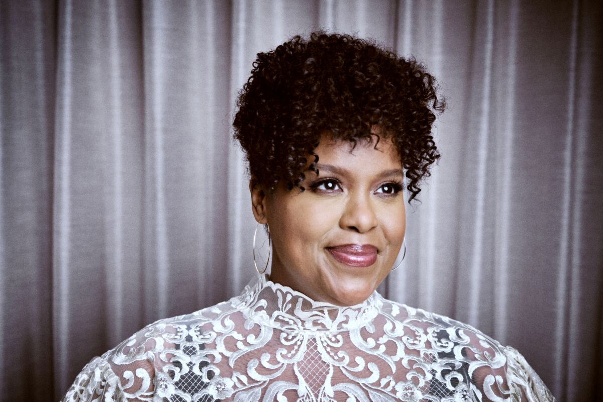 Natasha Rothwell  in a white and black patterned outfit