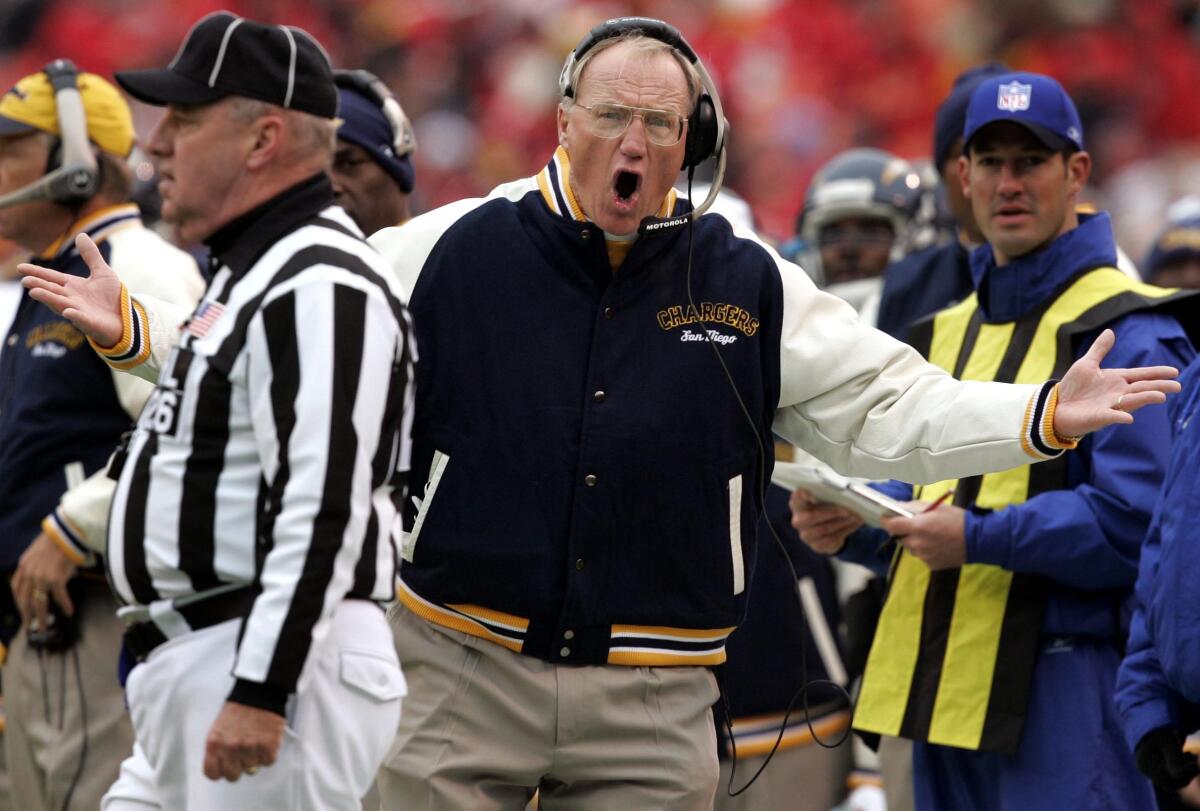 Chargers coach Marty Schottenheimer argues with linesman