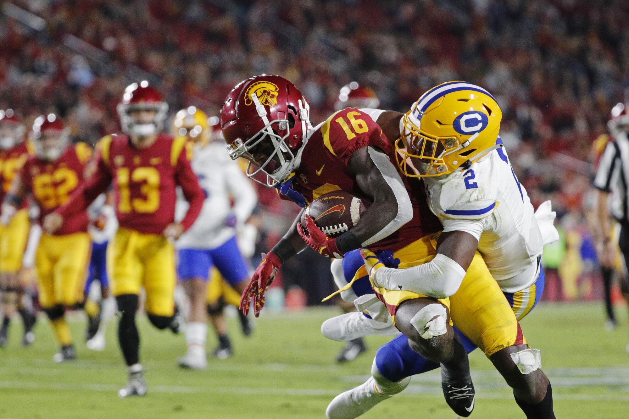 USC wide receiver Tahj Washington is tackled by California safety Craig Woodson after a 17-yard catch.