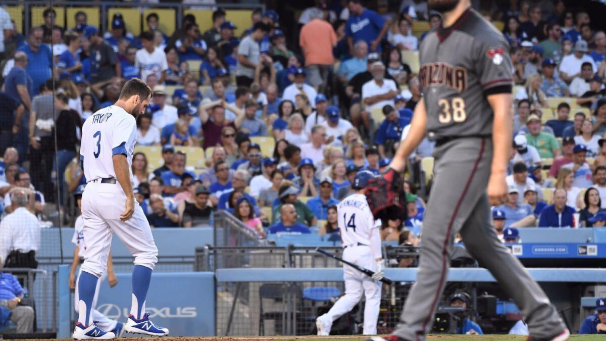 Dodgers outfielder Chris Taylor walks away after striking out in the sixth inning against the Arizona Diamondbacks pitcher Robbie Ray at Dodger Stadium on Monday.