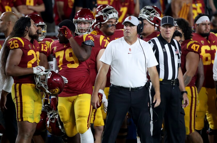 USC coach Clay Helton looks at the scoreboard in the closing minutes of a 42-28 loss to Stanford 