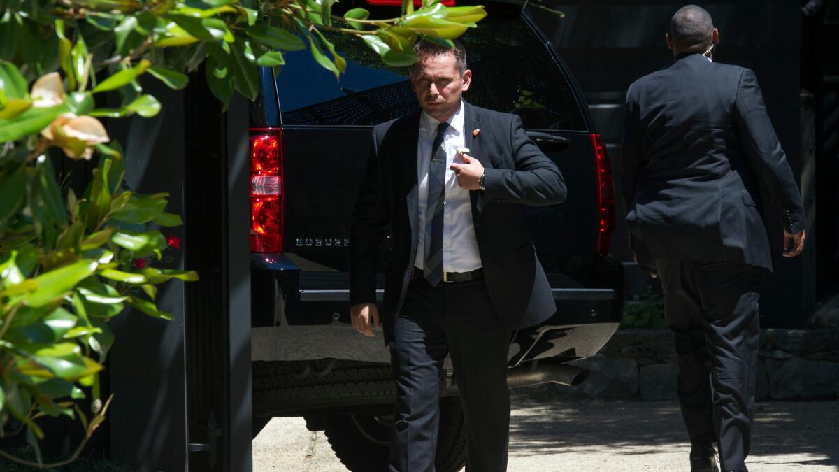Members of Hillary Clinton's Secret Service detail outside her home in Washington on Saturday after she returned from being interviewed at FBI headquarters about her use of a private email server while secretary of State.