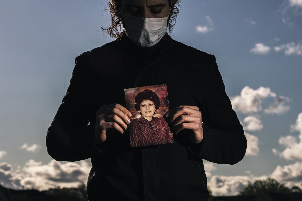 Amir holds a photograph of his late mother, 68-year old Azar Ahrabi, who was the Bay Area's first COVID-19 victim.