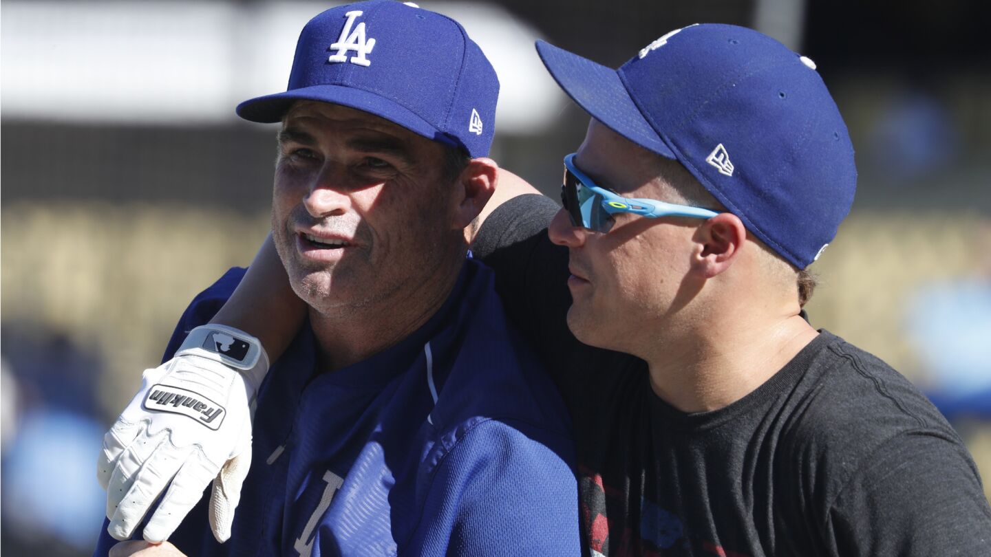 Dodgers outfielder Enrique Hernandez, right, shares a light moment with hitting coach Turner Ward before the start of Game 2.