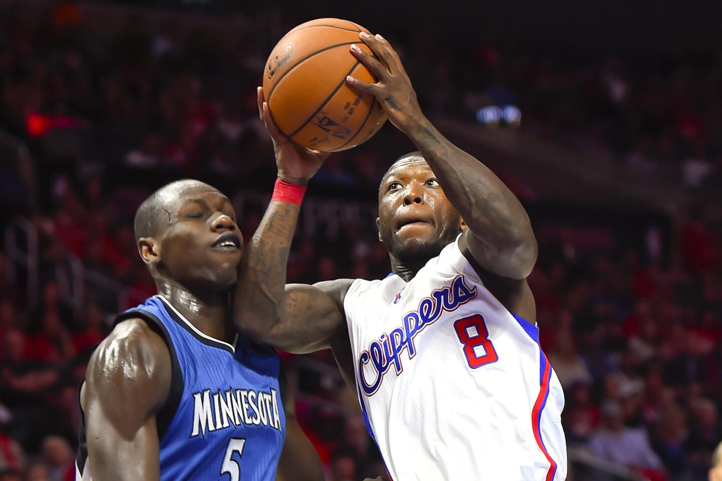 Former Clippers guard Nate Robinson drives past Timberwolves center Gorgui Dieng on March 9, 2015.