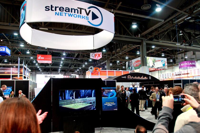 A crowd gathers to view Stream TV Network’s Ultra-D glasses-free 3-D technology at the Consumer Electronics Show in Las Vegas.