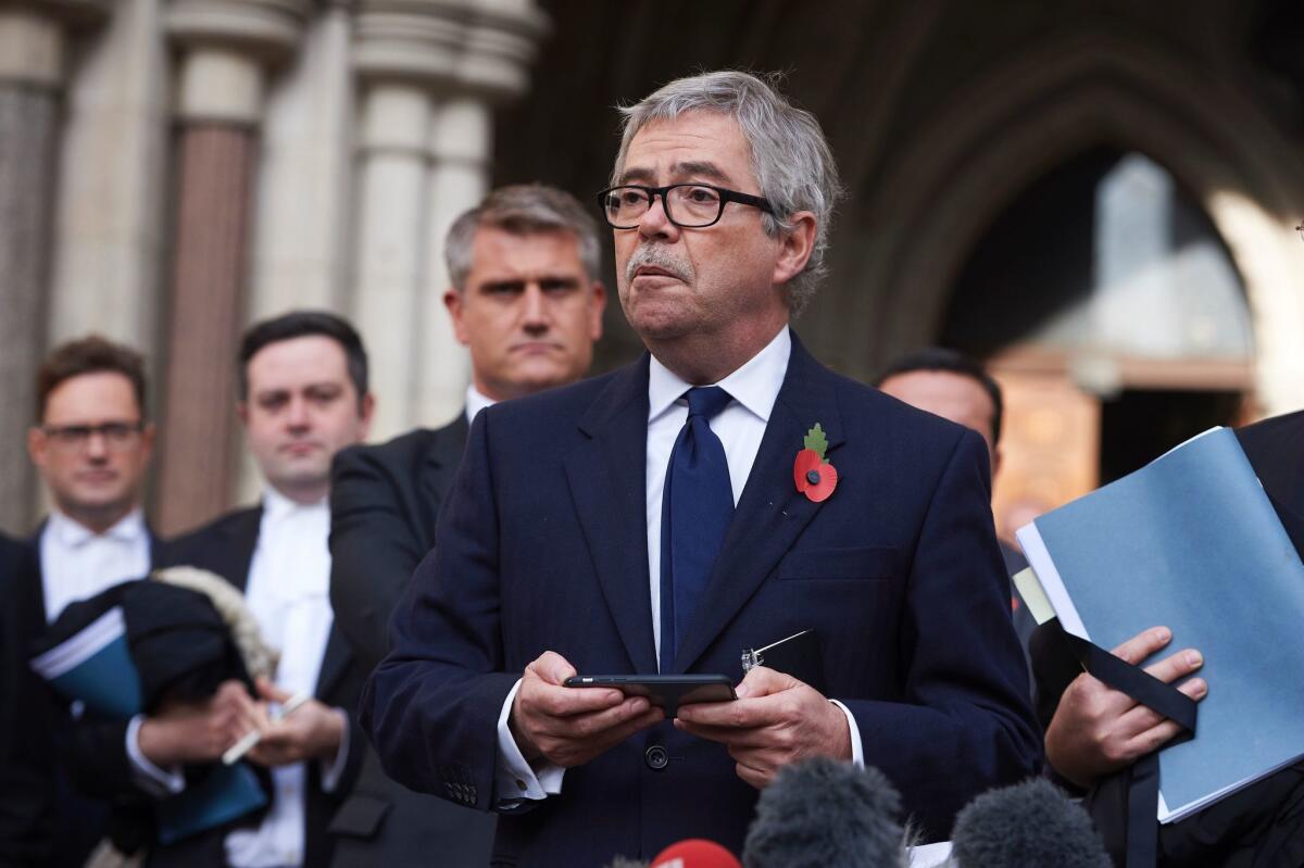 Lawyer David Greene reads a statement Thursday outside Britain's High Court about the ruling that the Brexit cannot be triggered without a vote by Parliament.