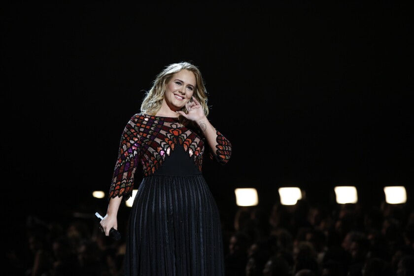 Adele at the 2017 Grammys, wearing a gown creating a stained-glass effect.