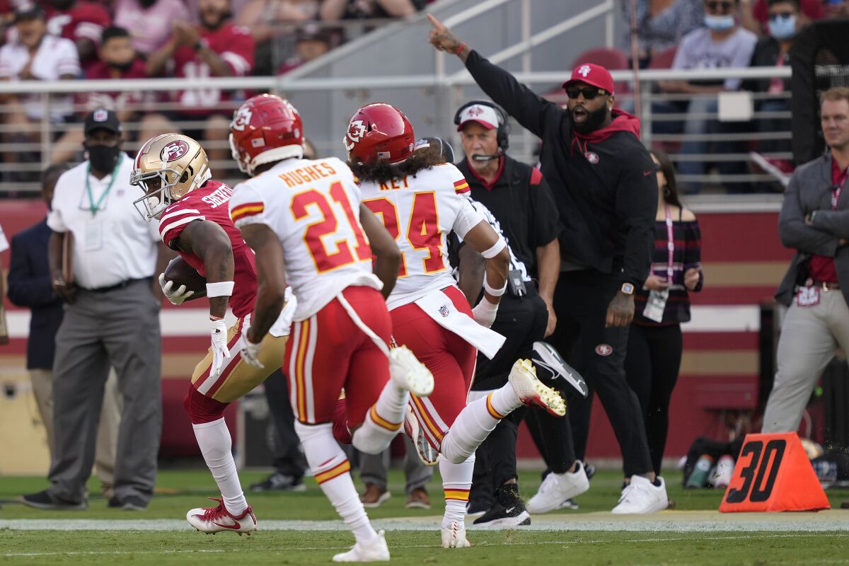 San Francisco 49ers wide receiver Trent Sherfield, left, runs in front of Kansas City Chiefs cornerback Mike Hughes (21) and safety Devon Key (24) to score on a pass from quarterback Trey Lance an NFL preseason football game in Santa Clara, Calif., Saturday, Aug. 14, 2021. (AP Photo/Tony Avelar)