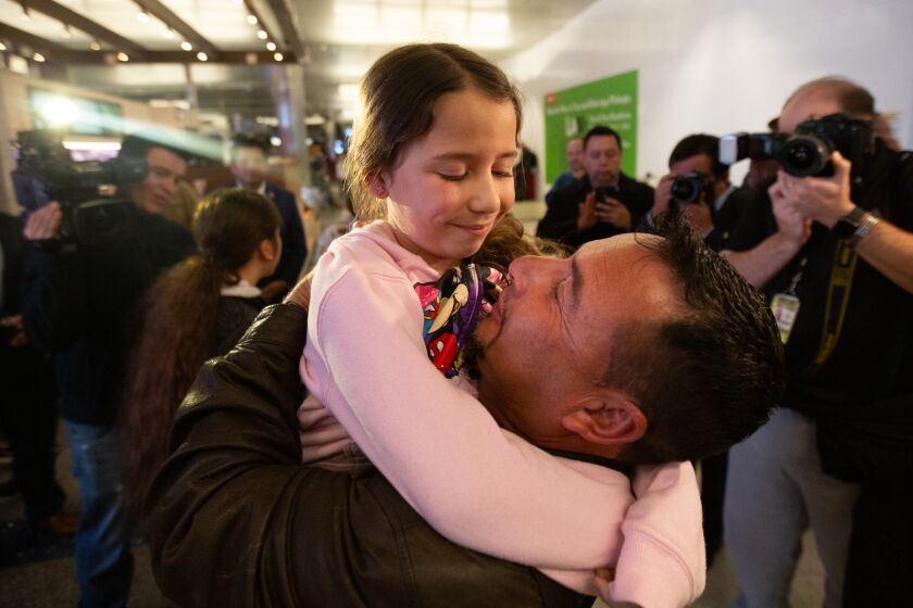Los Angeles, CA., January 22, 2020 — Fernando Arredondo embraces his daughter, Alison Arredondo, at LAX on Wednesday, January 22, 2020 in Los Angeles, California. Arredondo was one of 11 parents who were deported without their children during the zero tolerance policy. Nine of the parents returned to the U.S. on Wednesday and were reunited with their families. (Jason Armond / Los Angeles Times)