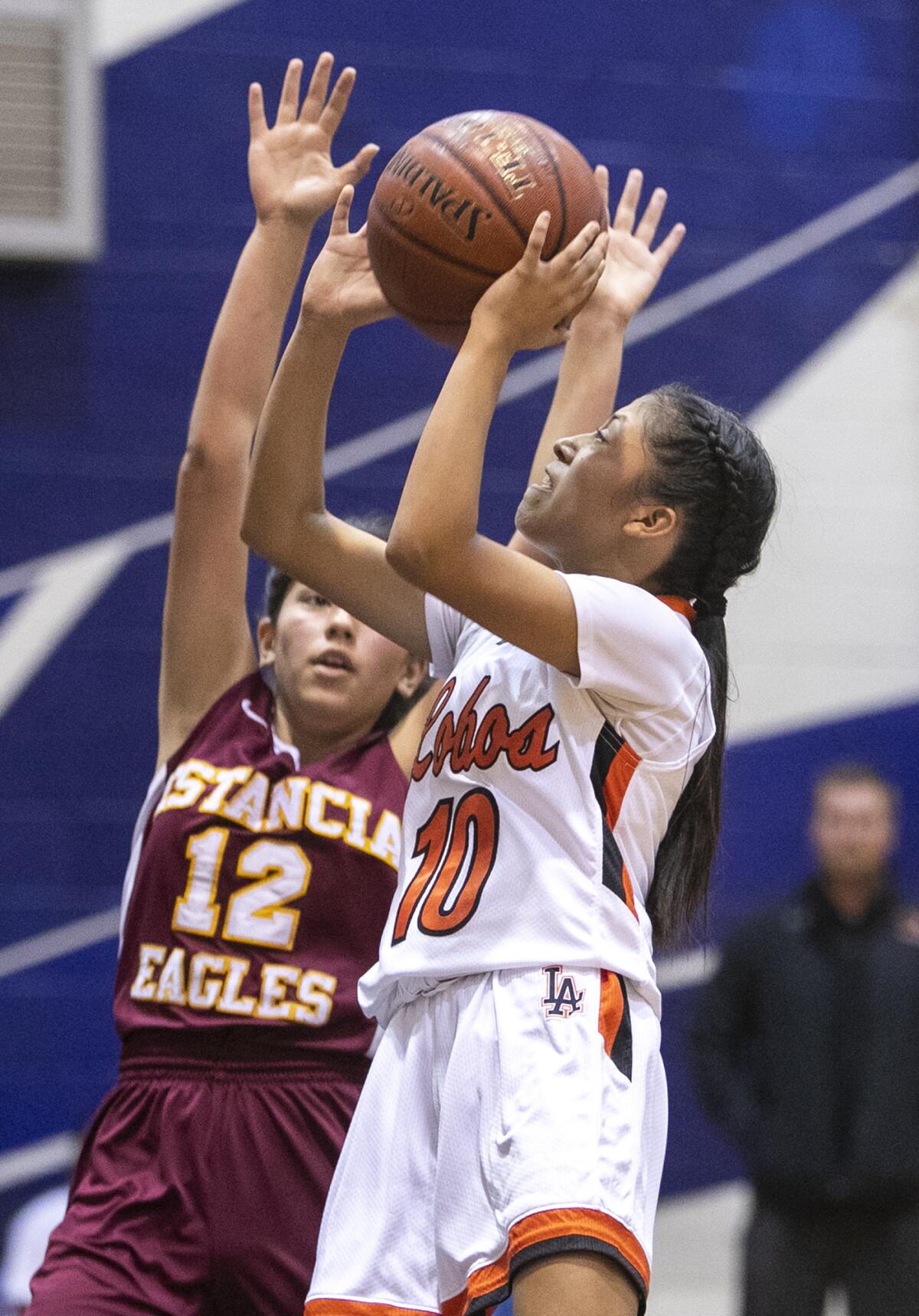 Los Amigos' Alexandra Lopez goes up for a shot against Estancia's Sammy Villalpando in a Hawk Holiday Classic game on Wednesday at Liberty Christian School.