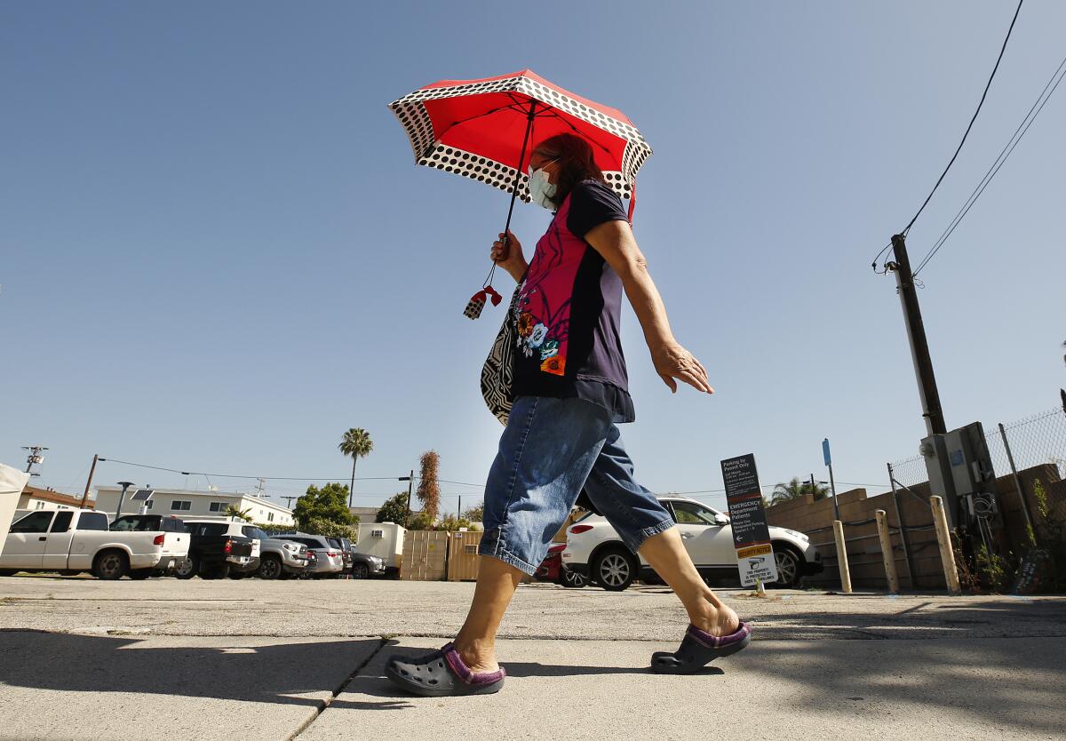 Maria Huff, 68, of Atwater Village uses an umbrella in Glendale on Tuesday.