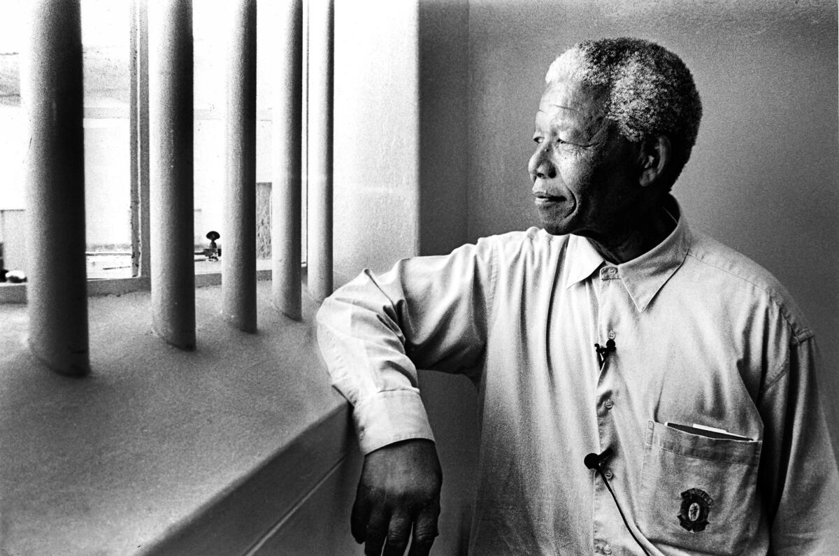 Nelson Mandela revisits his prison cell on Robben Island in 1994.