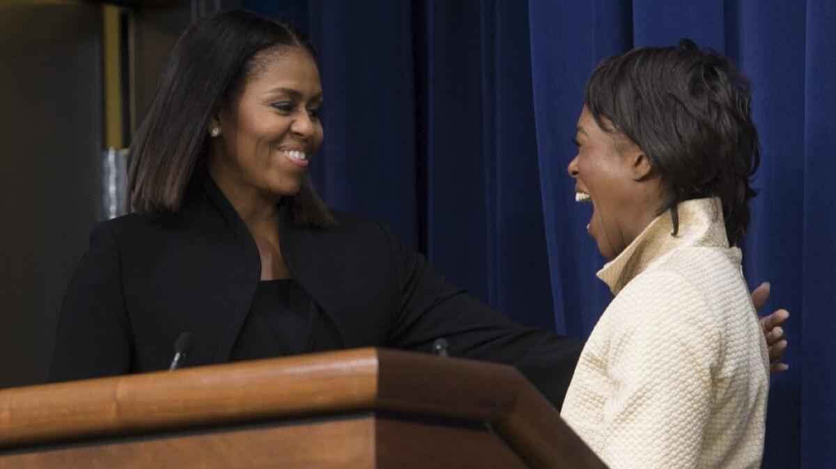 First Lady Michelle Obama, left, greets author Margot Lee Shetterly, who wrote the book that the hit movie, "Hidden Figures, " is based on, during a visit to the White House on Dec. 15, 2016.