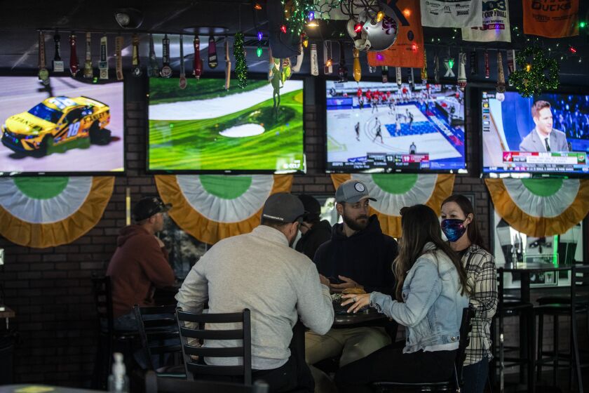 Patrons sit indoors for the first time in months at Kelly's Korner sports bar on Sunday, March 14, 2021 in Placentia, CA.  