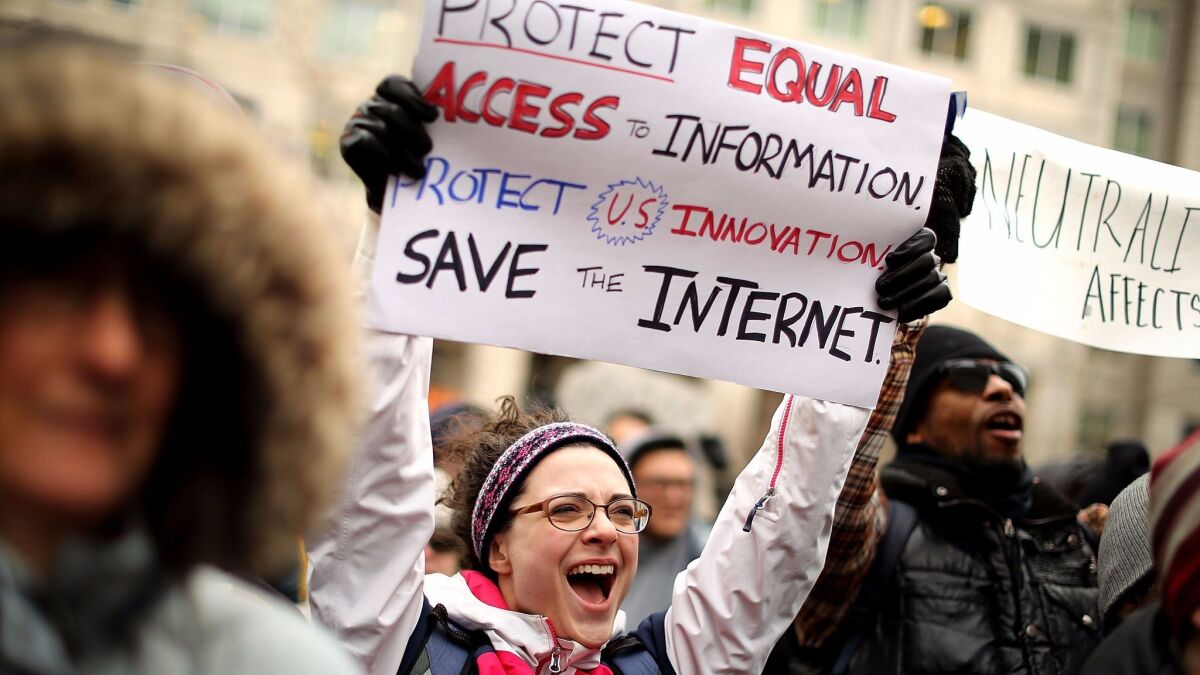 Demonstrators rally outside the Federal Communication Commission building Thursday to protest the repeal of net nutrality rules.