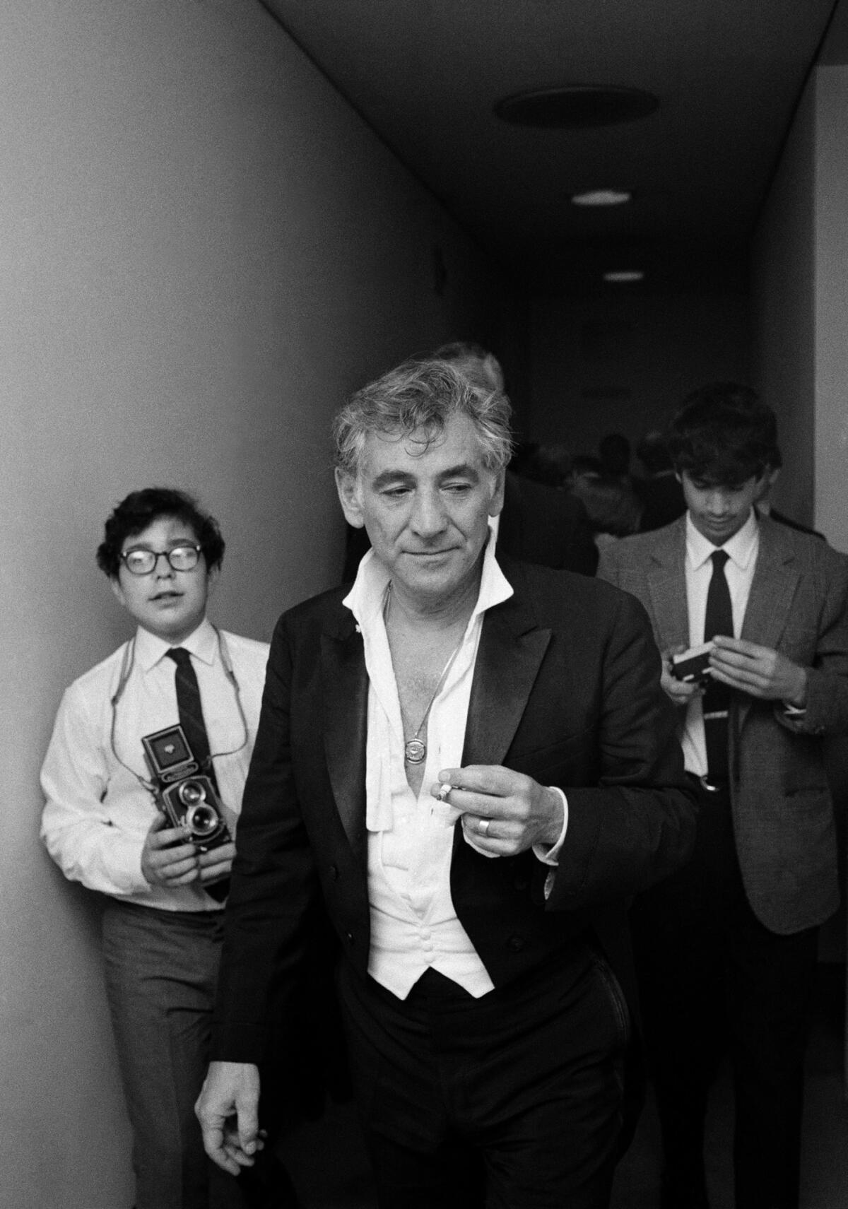 Leonard Bernstein walks to his dressing room following his last performance as music director of the New York Philharmonic in 1969.