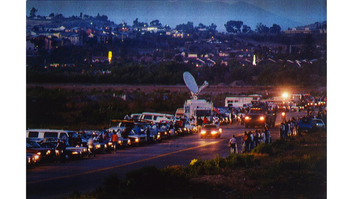 May 25, 1990: Supporters of the Light Up the Border movement shine headlights across a San Diego road, past a line of counterprotesters, to illuminate an area where immigrants enter the United States.