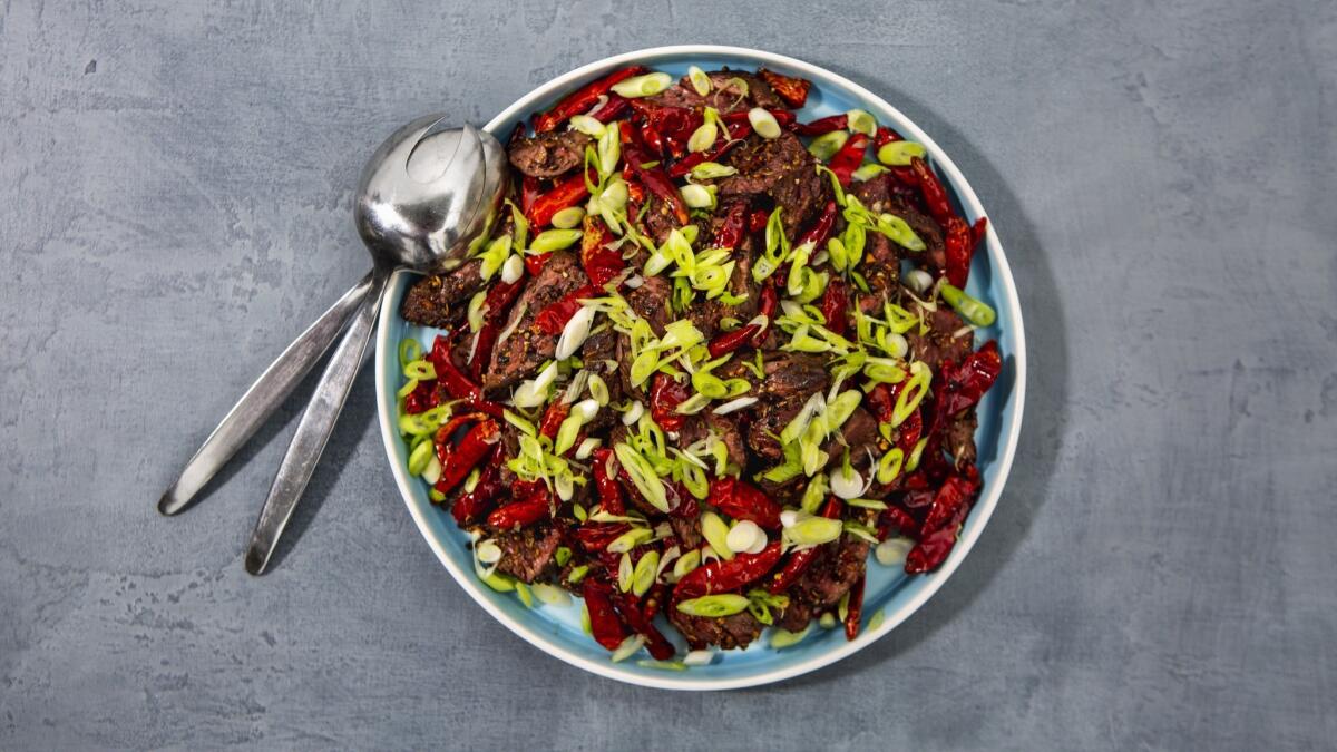 Thinly sliced hanger steak tossed with garlic, Sichuan and black peppercorns, and Japones chiles for a spicy, bold stir fry-like dish.