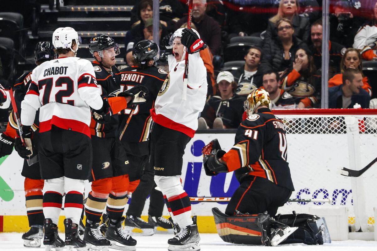 Senators forward Brady Tkachuk, second from right, celebrates after scoring on Ducks goalie Anthony Stolarz on Nov. 25, 2022.