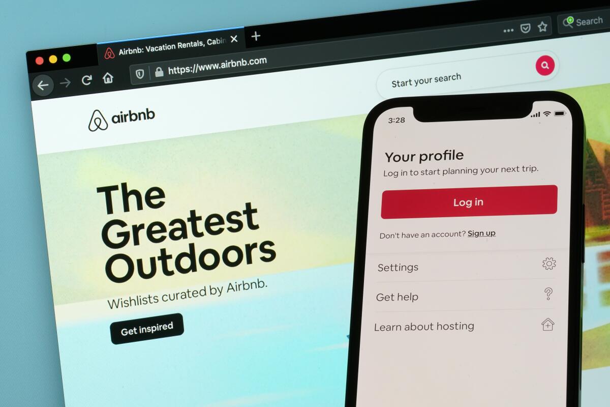 The login page for Airbnb's iPhone app is displayed on a computer displaying Airbnb's website