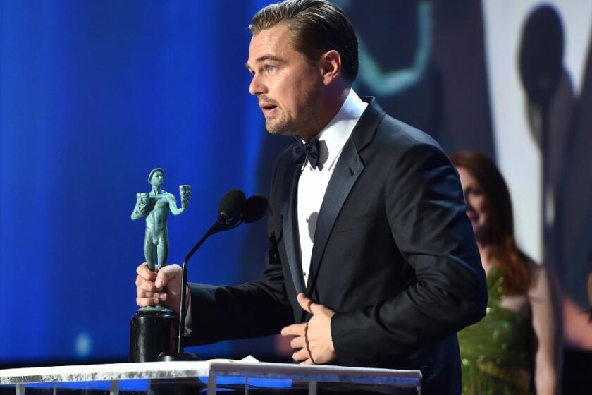 Leonardo DiCaprio accepts the male lead actor award from the Screen Actors Guild on Sunday for "The Revenant."