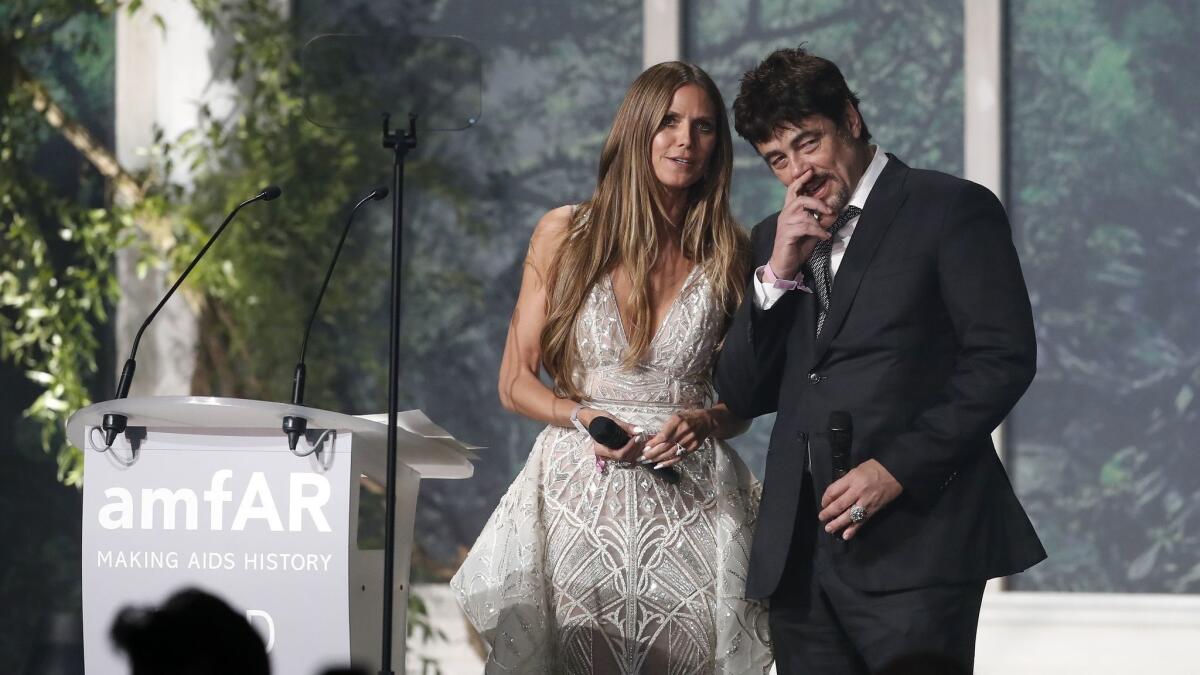 Heidi Klum and Benicio Del Toro attend this year's amfAR gala.