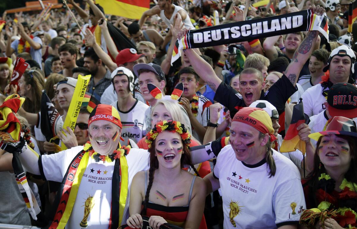 FILE --German soccer fans celebrate after the Brazil World Cup quarter final soccer match between Germany and France at a public viewing event in Berlin, Germany, Friday, July 4, 2014. (AP Photo/Michael Sohn,file)