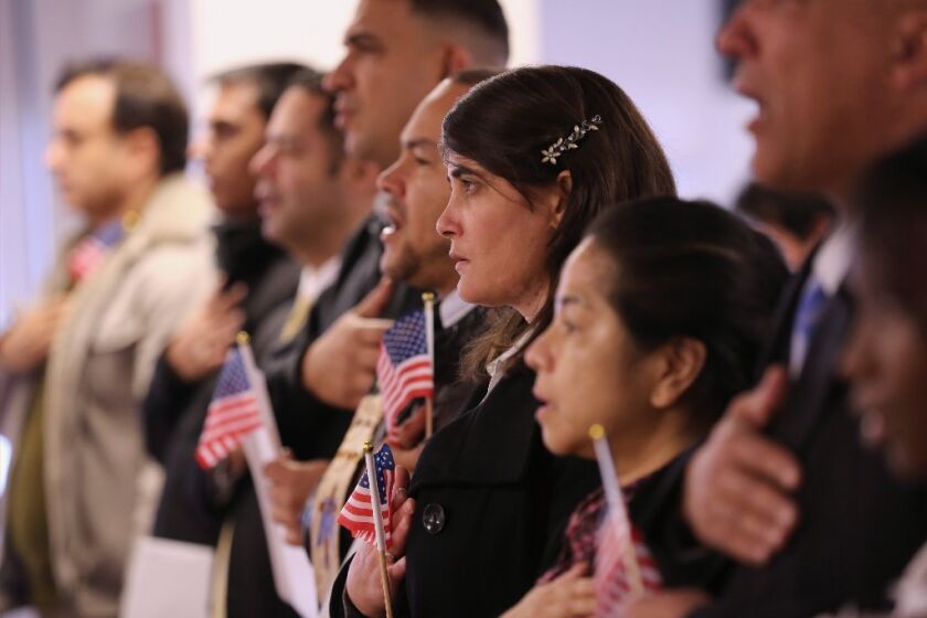 Immigrants take the oath of citizenship to the United States on Nov. 20 in Newark, N.J.