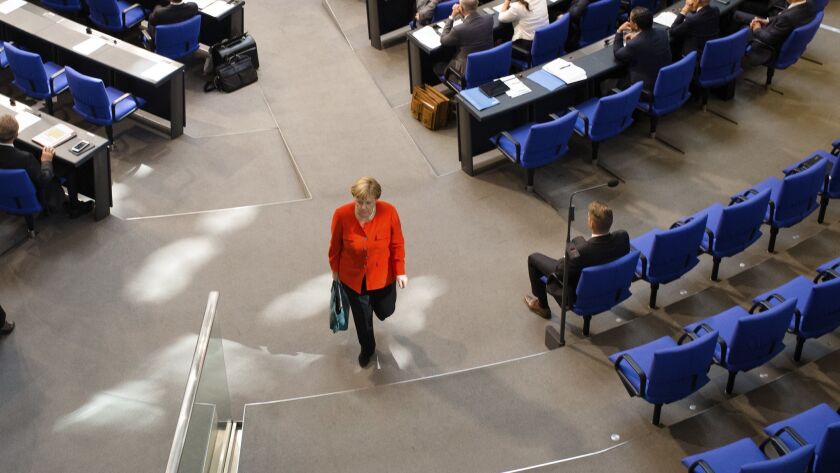 German Chancellor Angela Merkel leaves a plenary session of the German parliament in Berlin on Wednesday.
