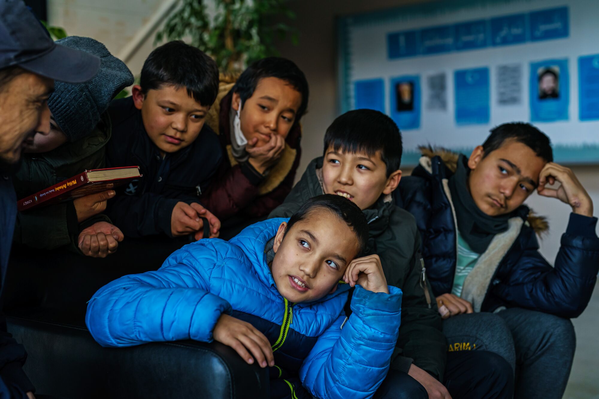 Uyghur students interact with Aqil Abdullah, their English teacher, at an orphanage and school for Uyghur children