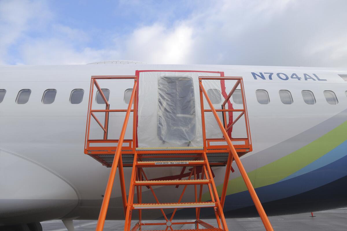 Plastic covers a door-like hole in the fuselage of an airplane.