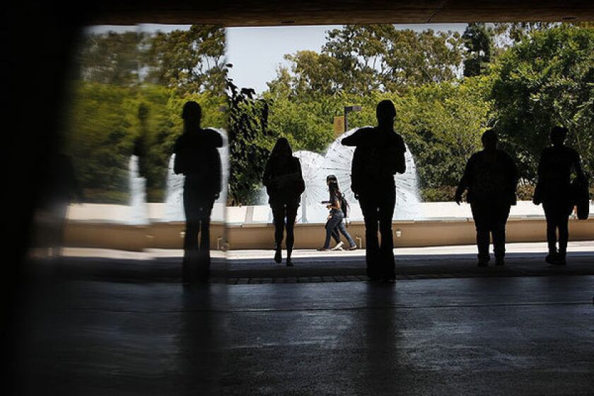 Students walk between Lough Memorial Fountain and Brotman Hall at Cal State Long Beach.