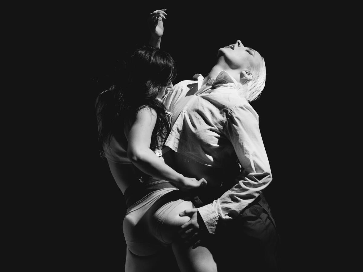 Two people dancing sensually against one another. 