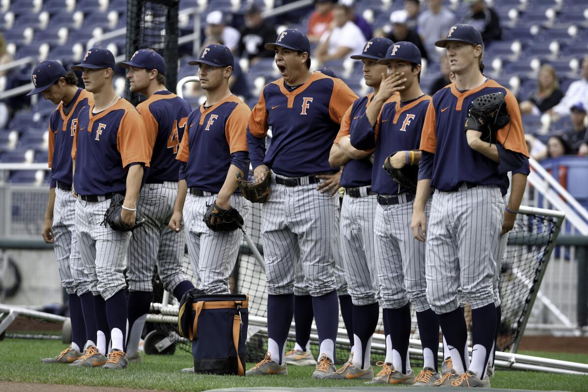 Cal State Fullerton wait for their turn to use the field at TD Ameritrade Park before the start of the College World Series in Omaha, Neb.