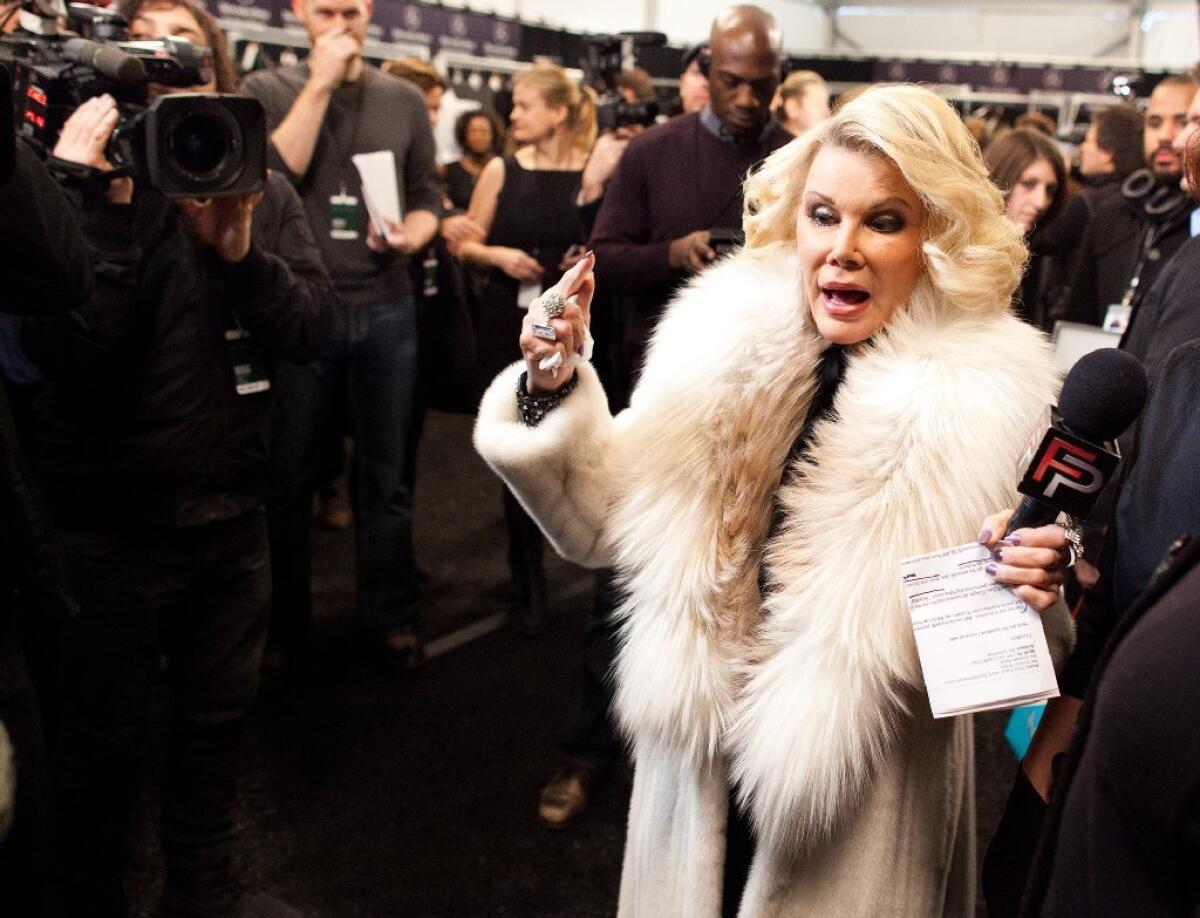 Joan Rivers tours backstage with her camera crew for E!'s "Fashion Police " before the Badgley Mischka show during Fashion Week in New York in 2012.