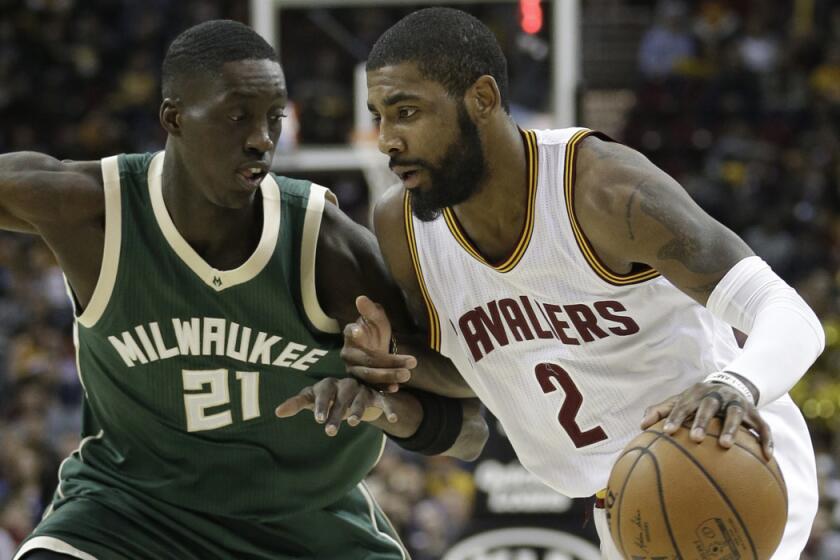 Cleveland Cavaliers' Kyrie Irving (2) drives past Milwaukee Bucks' Tony Snell (21) during the first half on Wednesday.