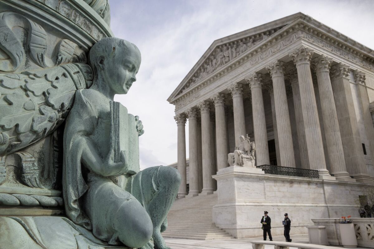 A cherub holding an open book adorns a flagpole on the plaza of the Supreme Court in Washington, D.C. The justices ruled on Monday in a case involving the constitutional principle of “one person, one vote.”