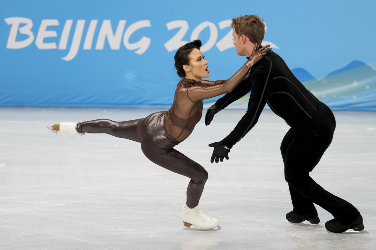 Figure skating pair Madison Chock and Evan Bates take part in a training session at the Beijing Olympics on Sunday.