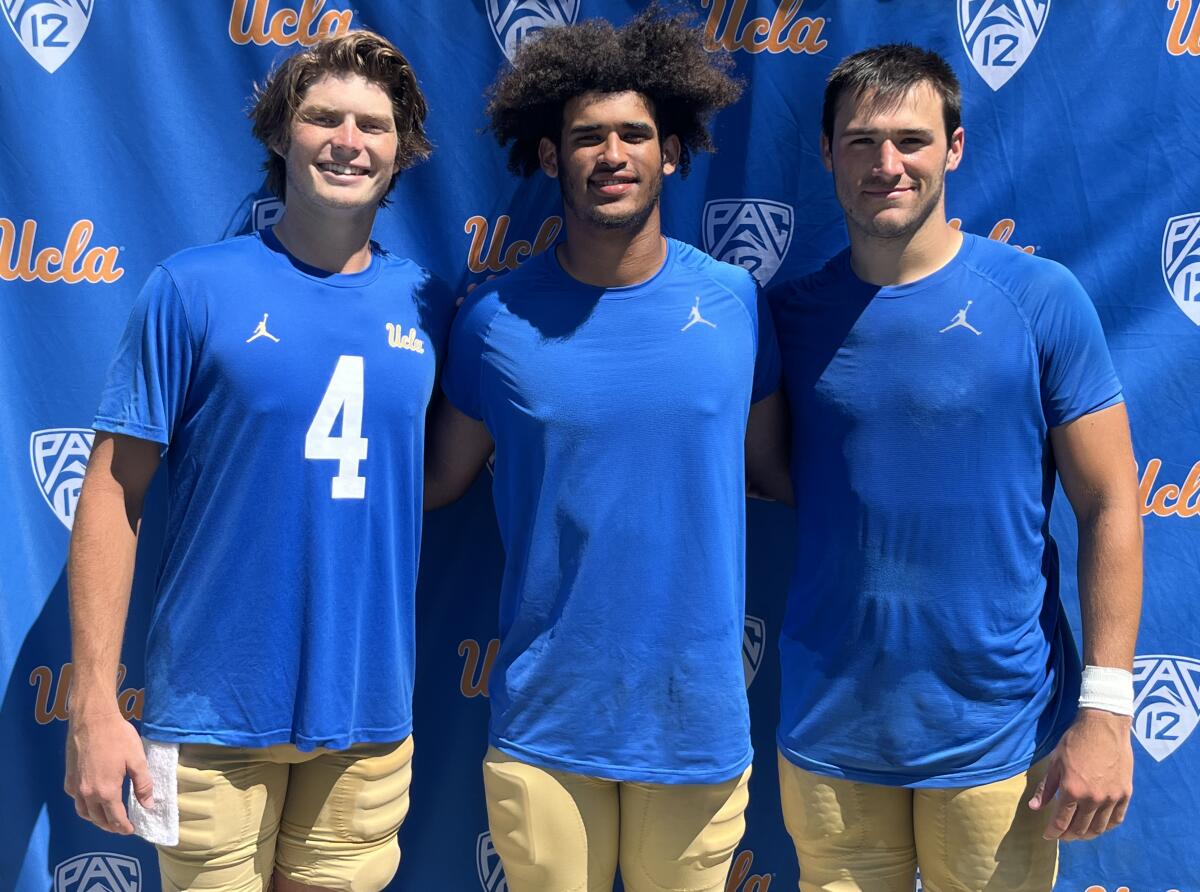 UCLA quarterbacks Ethan Garbers, Dante Moore and Collin Schlee pose for a photo after practice