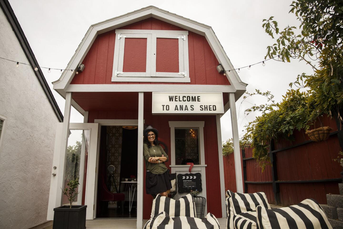 Ana Machado stands for a portrait with her she shed in her backyard in Oceanside, Calif.