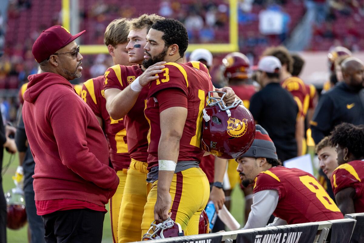 USC quarterback Caleb Williams gets a hug from backup quarterback Miller Moss.