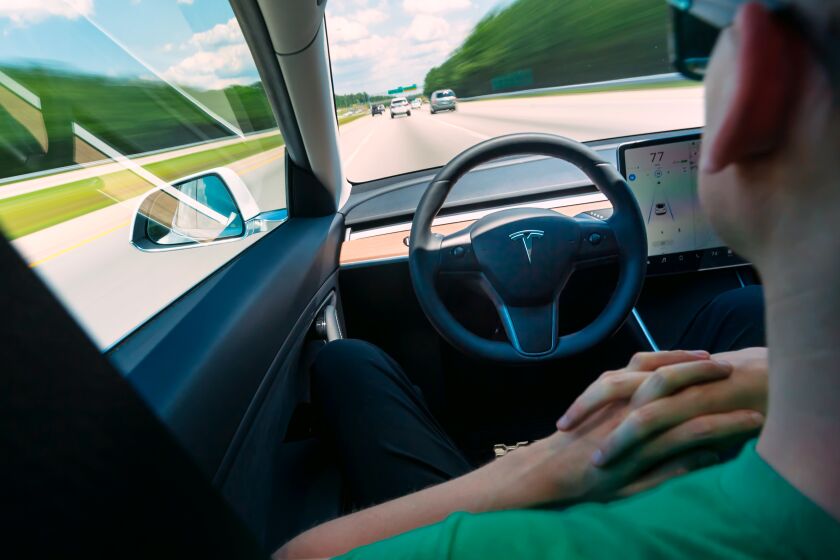 Man using the autopilot self-driving function in an all electric Tesla Model 3 (Dreamstime/TNS) ** OUTS - ELSENT, FPG, TCN - OUTS **