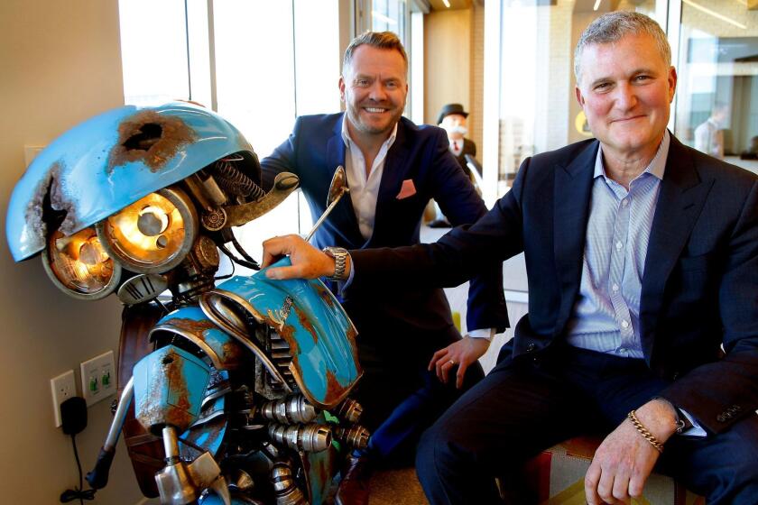 Hasbro executives Simon Waters (Global Brand Licensing), Steve Davis (Chief Content Officer) and with SQUEAKS (a Vespa scooter), a new Transformer for the up coming "Transformer" movie