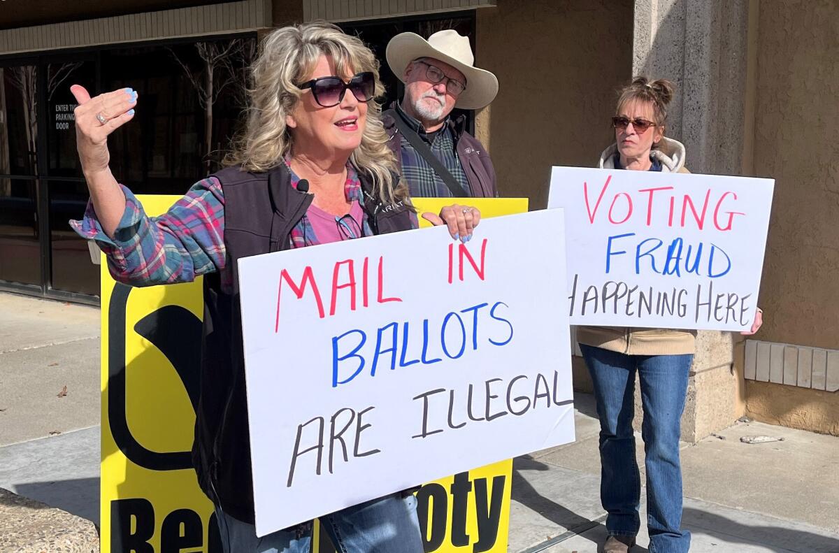 Recall supporter Patty Plumb (front) stands in front of the Shasta County Clerk's Office.