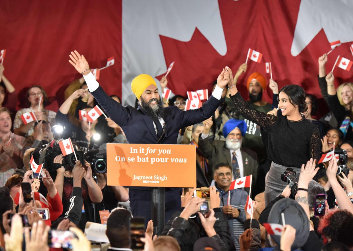 NDP leader Jagmeet Singh and his wife Gurkiran Kaur step on stage under the cheers of his supporters at the NDP Election Night Party in Burnaby BC, Canada, on October 21, 2019. Prime Minister Justin Trudeau's Liberal Party held onto power in a nail-biter of a Canadian general election on Monday, but as a weakened minority government.