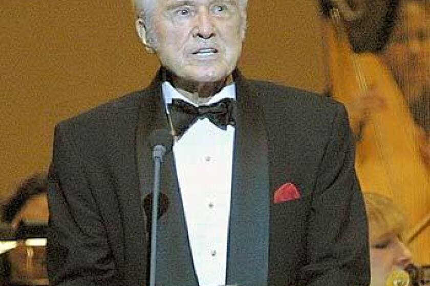 John Raitt introduces Rodgers & Hammerstein's "Carousel" to patrons at Carnegie Hall in New York in 2002. Raitt is the robust baritone who created the role of Billy Bigelow in the original New York production.