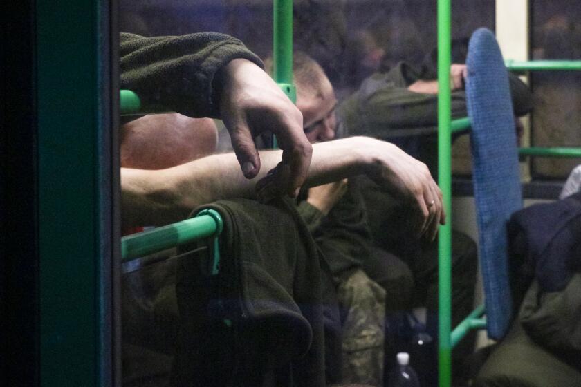 Ukrainian servicemen sit in a bus after they were evacuated from the besieged Mariupol's Azovstal steel plant
